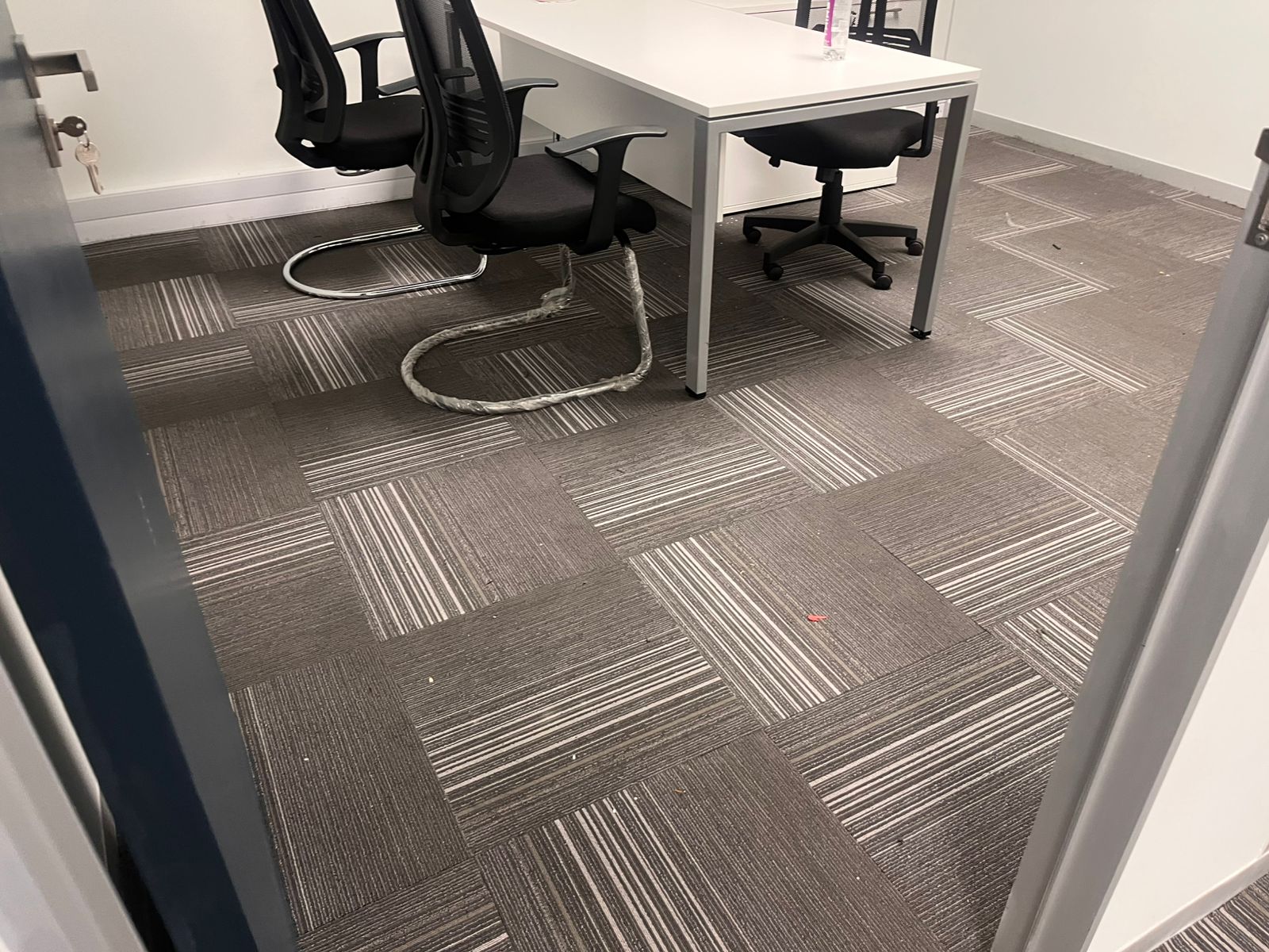 Office area showing desks and clean carpet